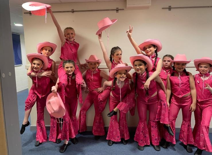 Smiling students performing in Bradford dance showcase